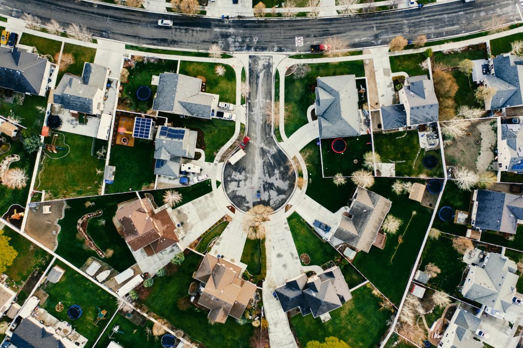 Aerial view showcasing a residential neighborhood in Herriman, Utah with modern architecture and green lawns.